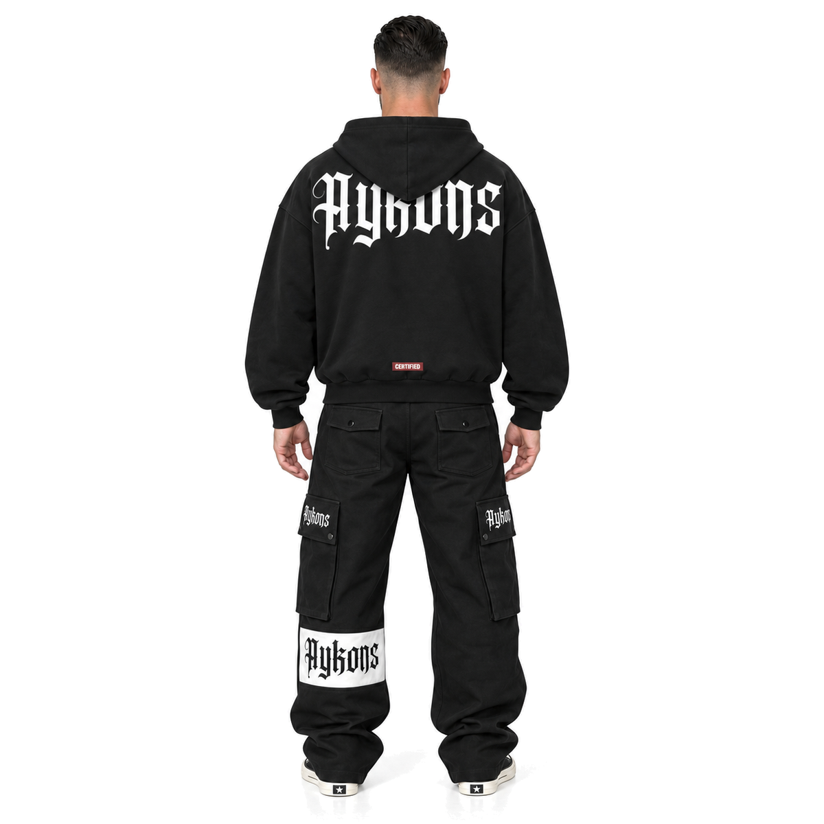 [400] Signature ZIP — model straight back, black Signature cargos and black and white Rick Owens Converse, pure white background.