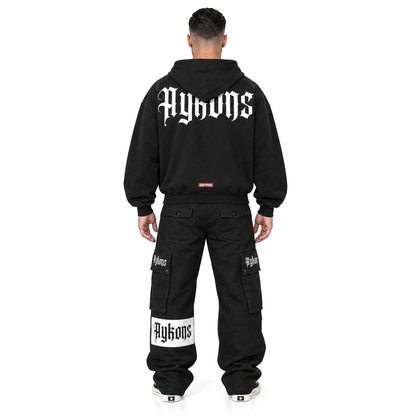 [400] Signature ZIP — model straight back, black Signature cargos and black and white Rick Owens Converse, pure white background.