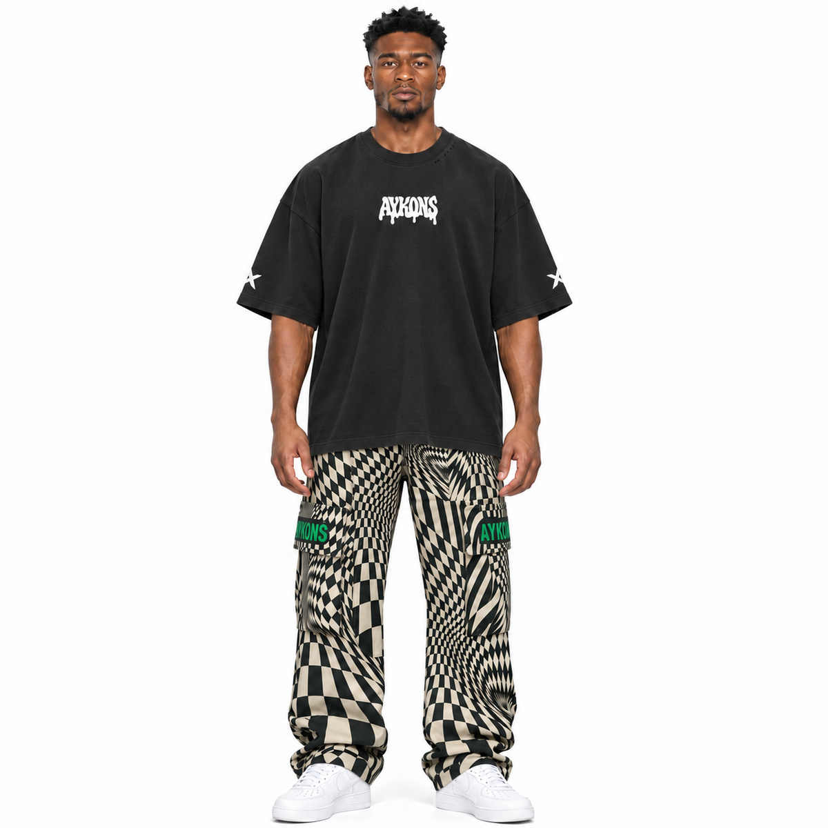 AYKONS Distorted Reality V2 cargo pants and PsySmile tee — model straight front, white Air Force 1 shoes.