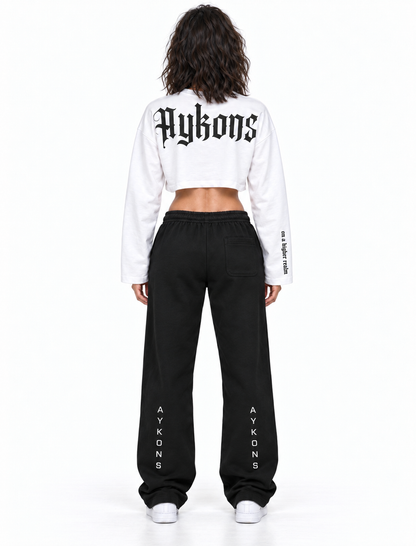 White and black AYKONS Racer Crop — Women Model 1 back view with black AYKONS sweatpants